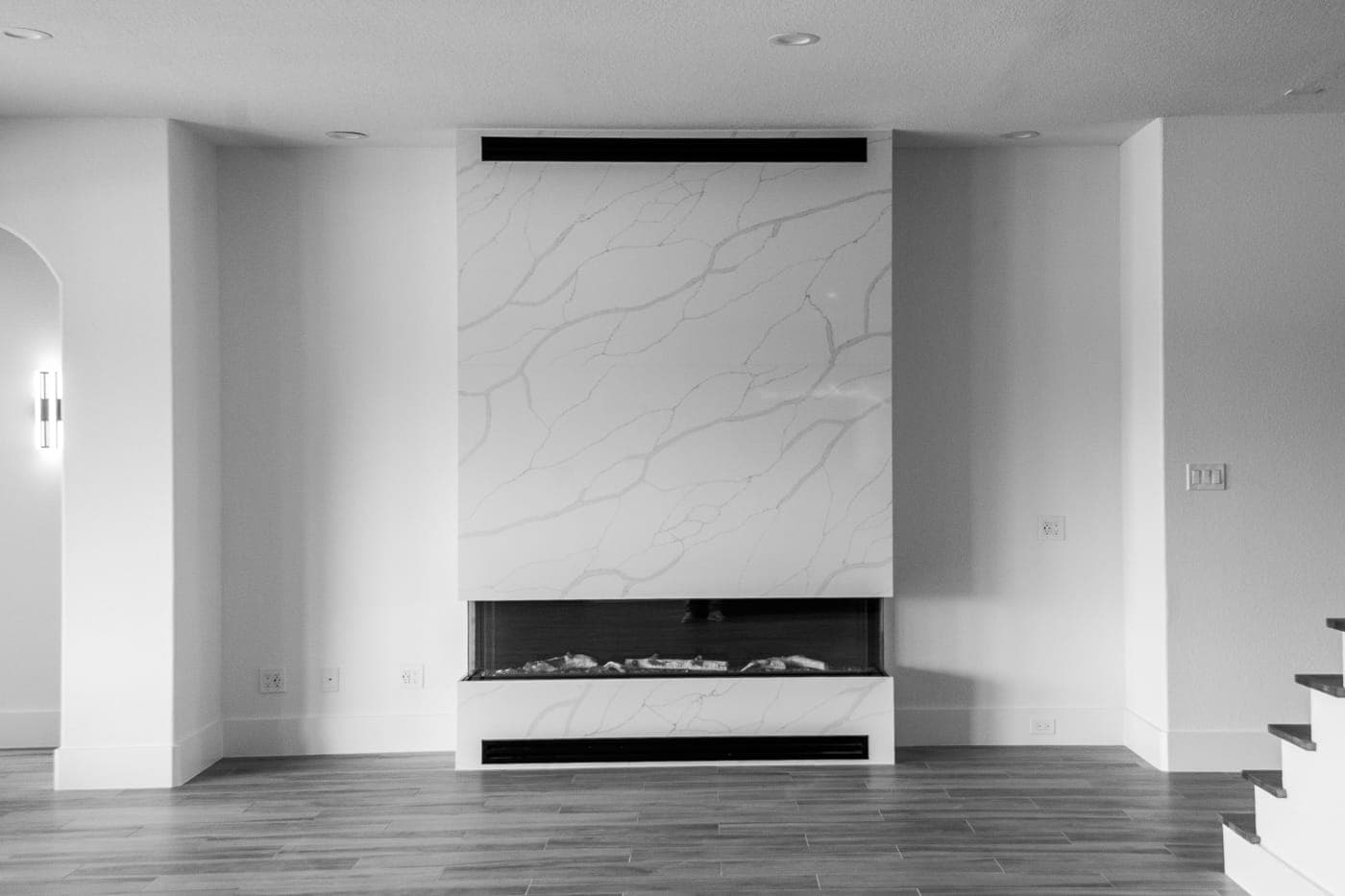 Living room with a full-height marble slab fireplace surround and linear gas insert