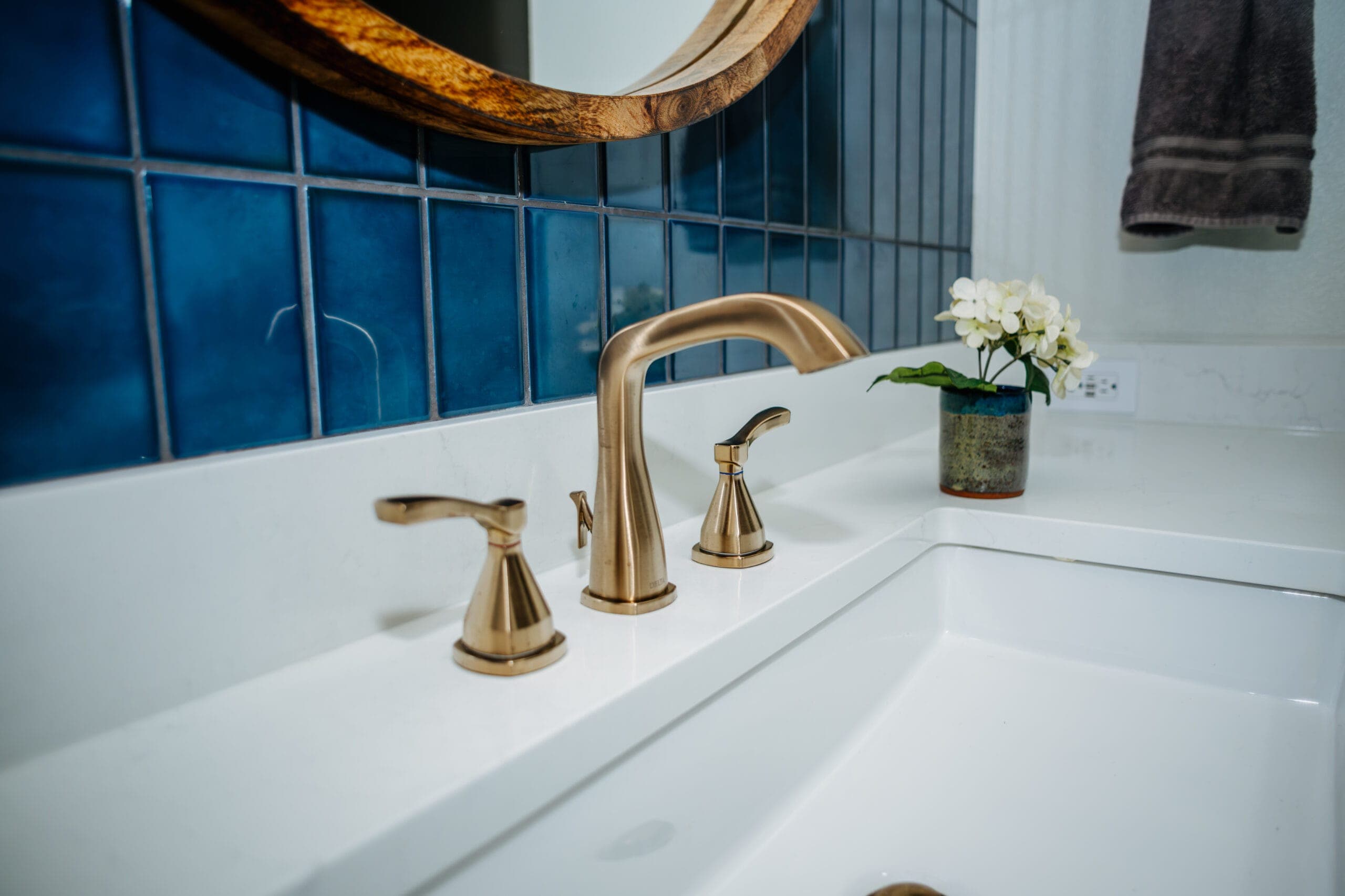 Brushed brass widespread faucet on a quartz vanity counter — Southlake Luxury Kitchens bathroom remodeling, serving Southlake, TX