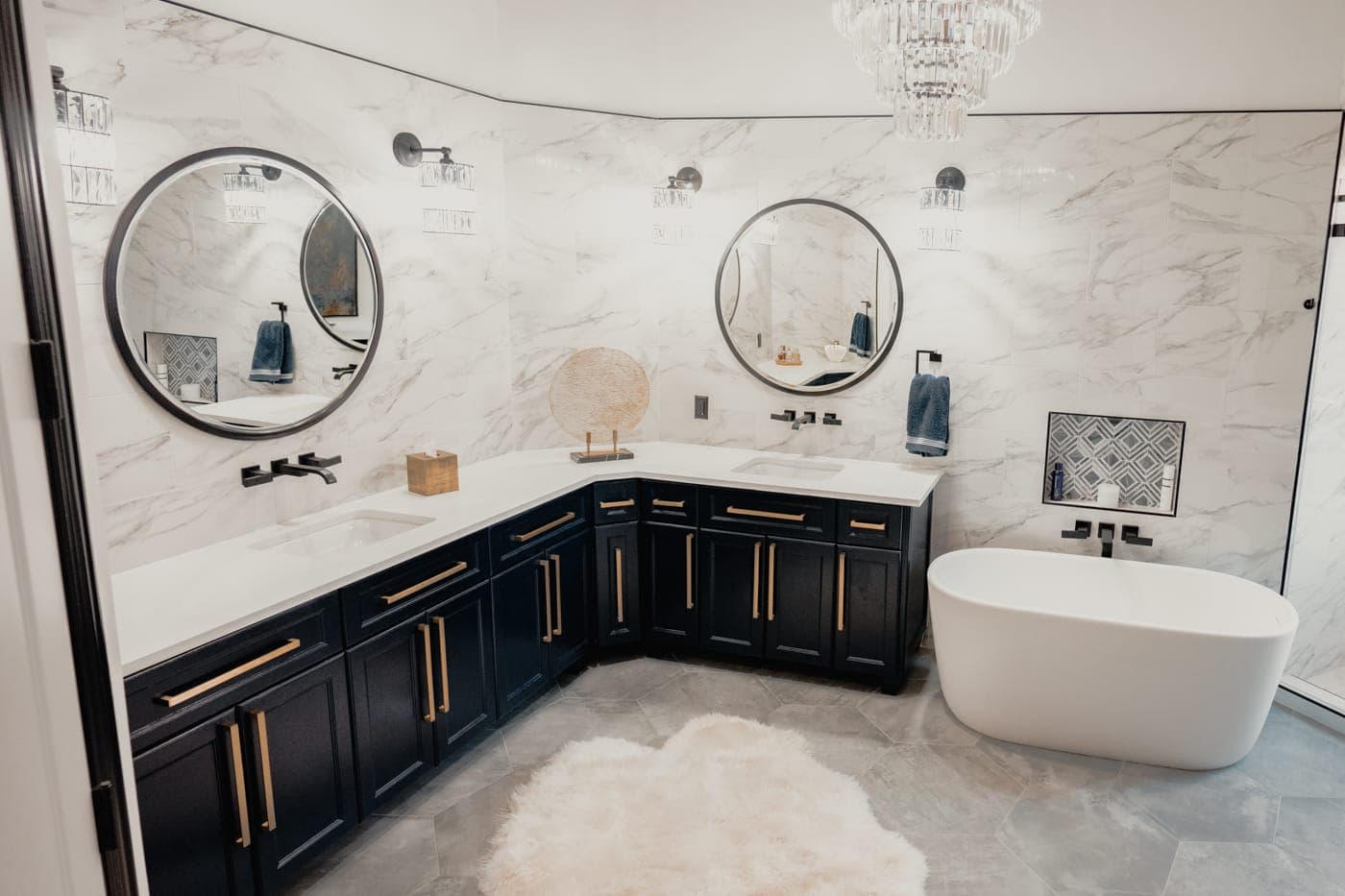 Corner navy vanity and freestanding soaking tub in a primary bathroom — Southlake Luxury Kitchens, serving Southlake, TX