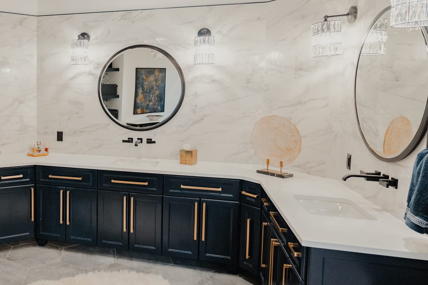 Navy double vanity with round black mirrors and crystal sconces — bathroom remodeling by Southlake Luxury Kitchens, serving Southlake, TX