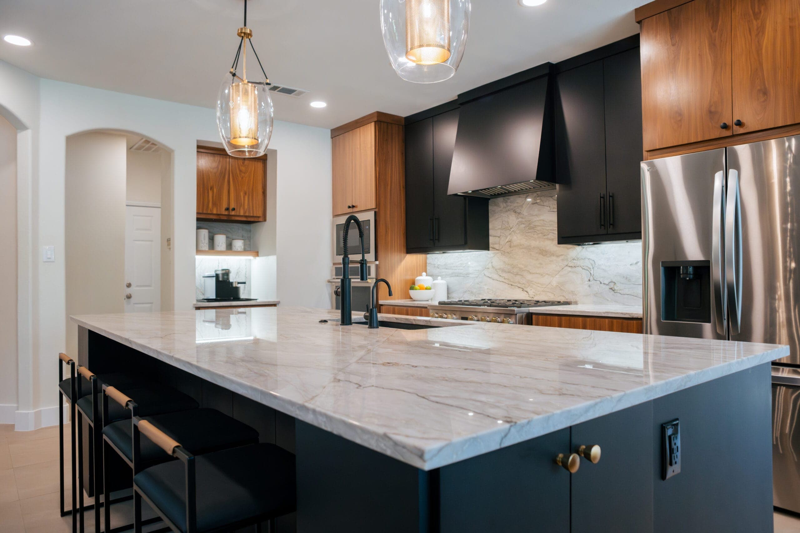 Quartzite waterfall island edge and prep sink in a two-tone kitchen remodel — Southlake Luxury Kitchens, serving Southlake, TX