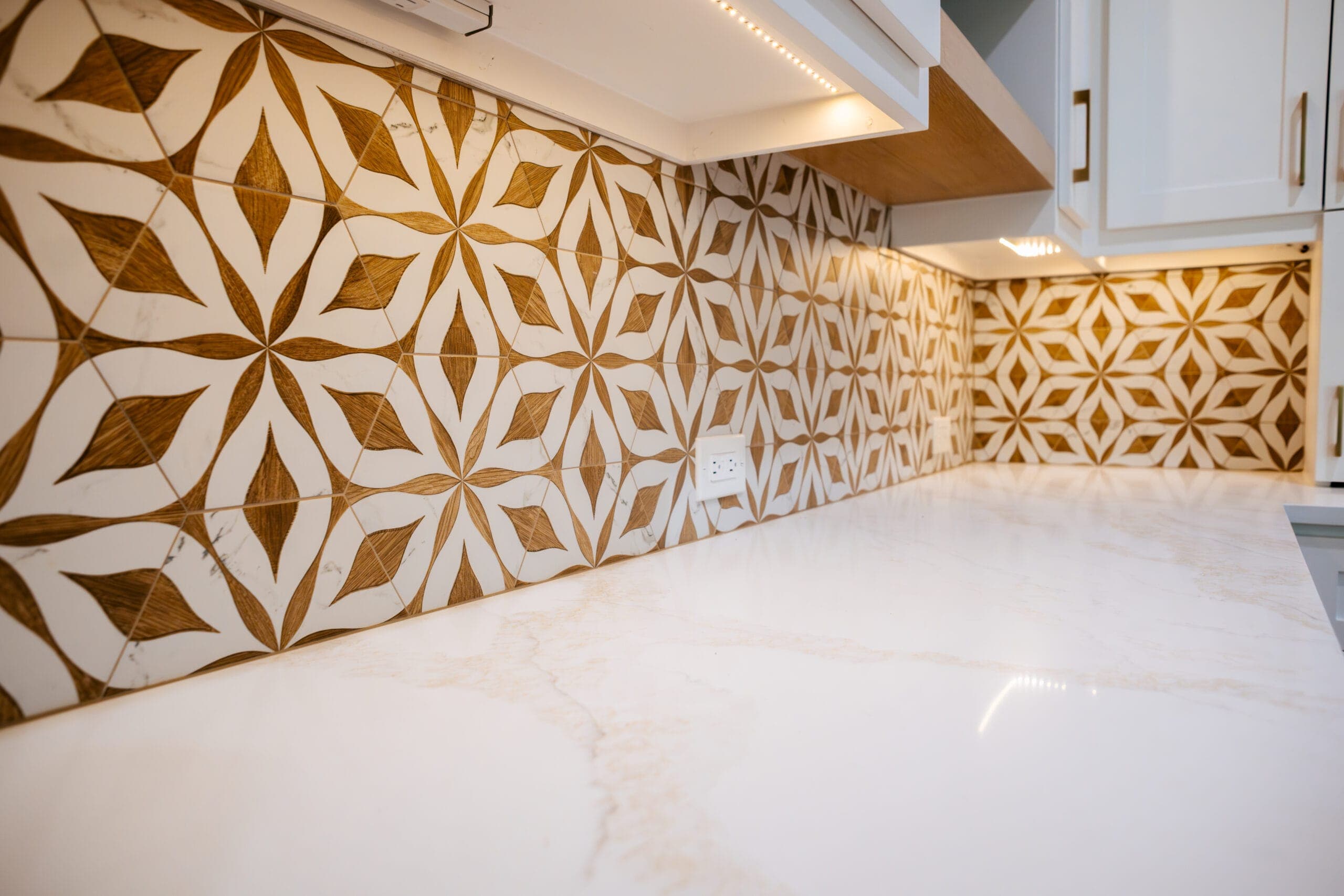 Gold and white geometric tile backsplash run full height above a quartz counter — kitchen remodeling by Southlake Luxury Kitchens, serving Southlake, TX