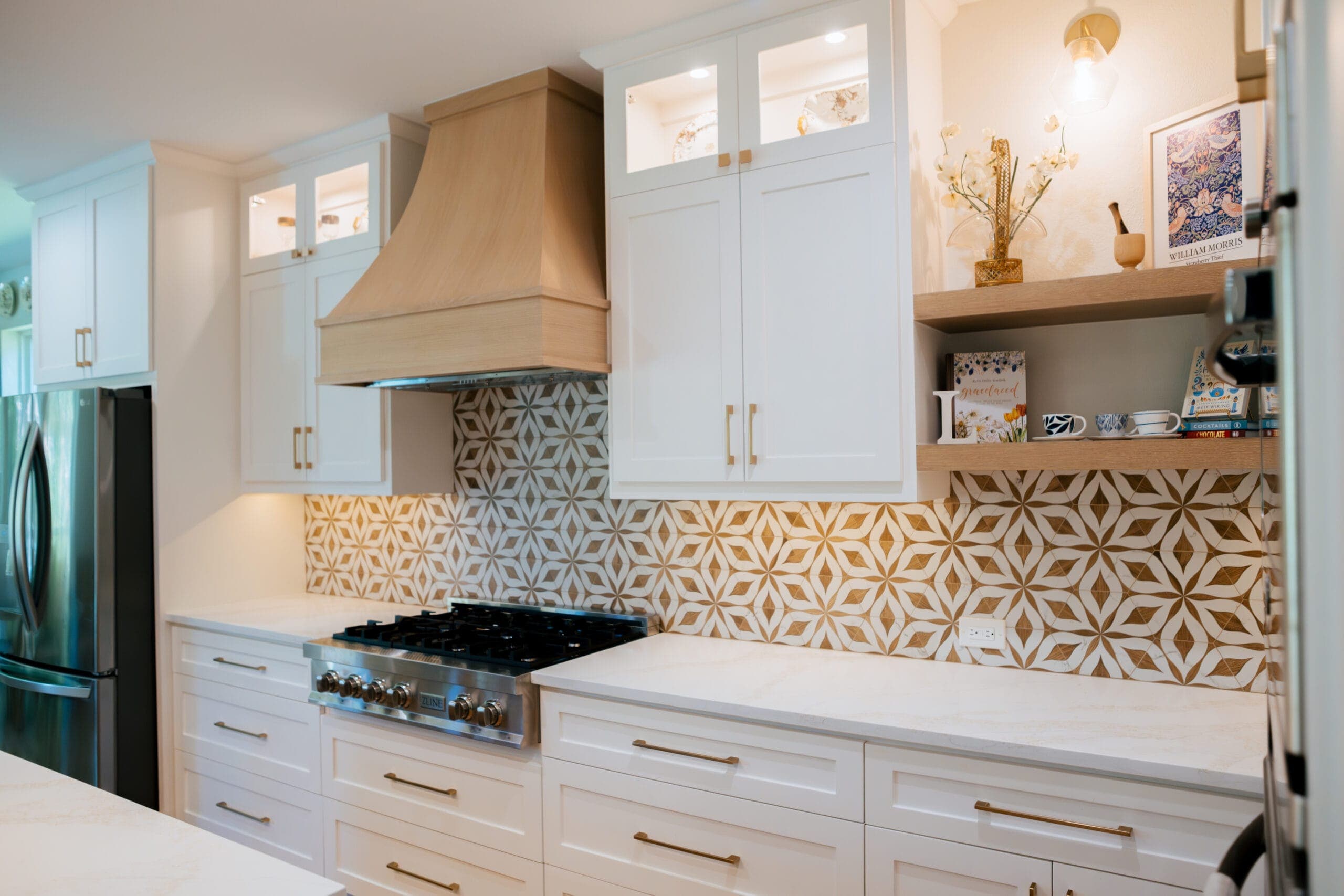 Rangetop wall with white oak hood, open shelving and gold geometric tile — kitchen remodeling by Southlake Luxury Kitchens, serving Southlake, TX