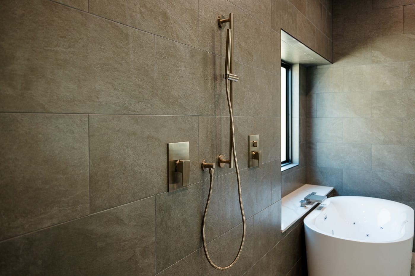 Wet room with dual brass shower heads and a freestanding tub — bathroom remodeling by Southlake Luxury Kitchens, serving Southlake, TX