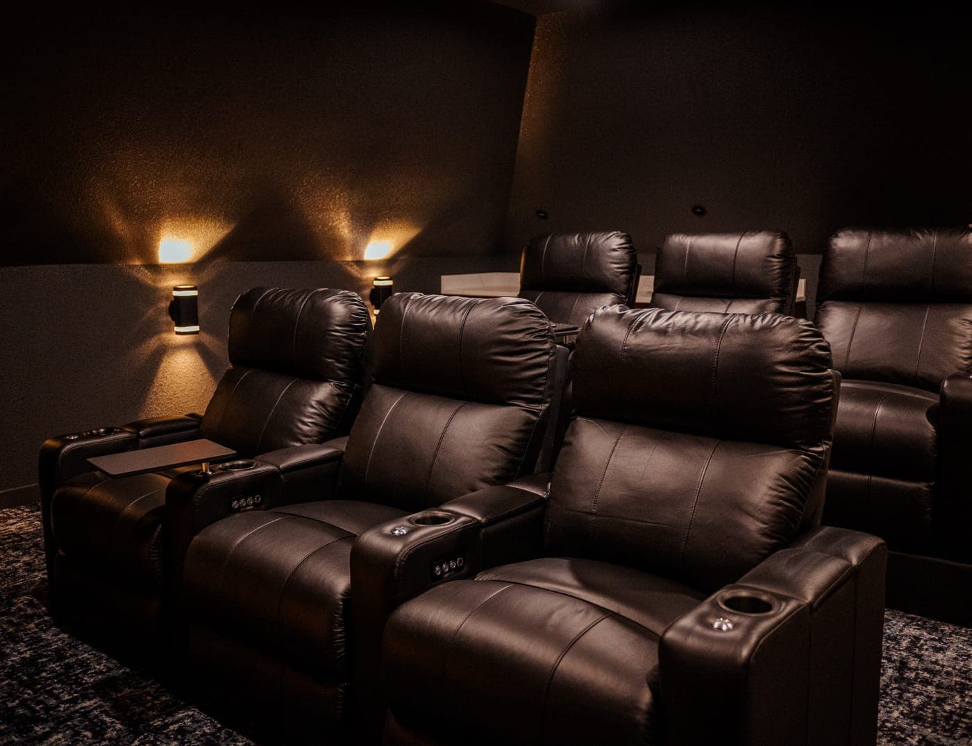 Home theater with tiered leather recliners and wall sconces — whole-home remodeling by Southlake Luxury Kitchens, serving Southlake, TX
