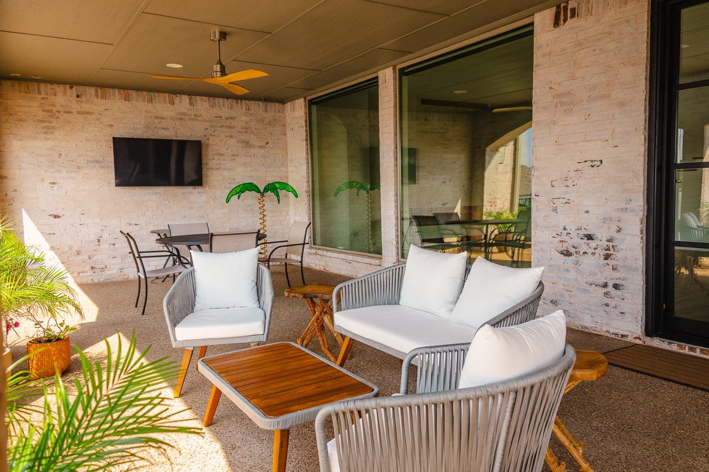 Covered outdoor living area with lounge seating and a mounted television — outdoor living by Southlake Luxury Kitchens, serving Southlake, TX